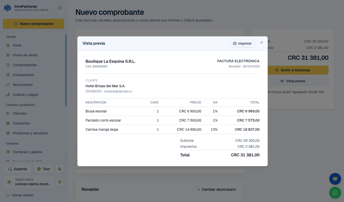 InnoFacturas en una computadora: vista previa de una factura electrónica con tres prendas, IVA del 1% y del 13% y el total, en modo claro